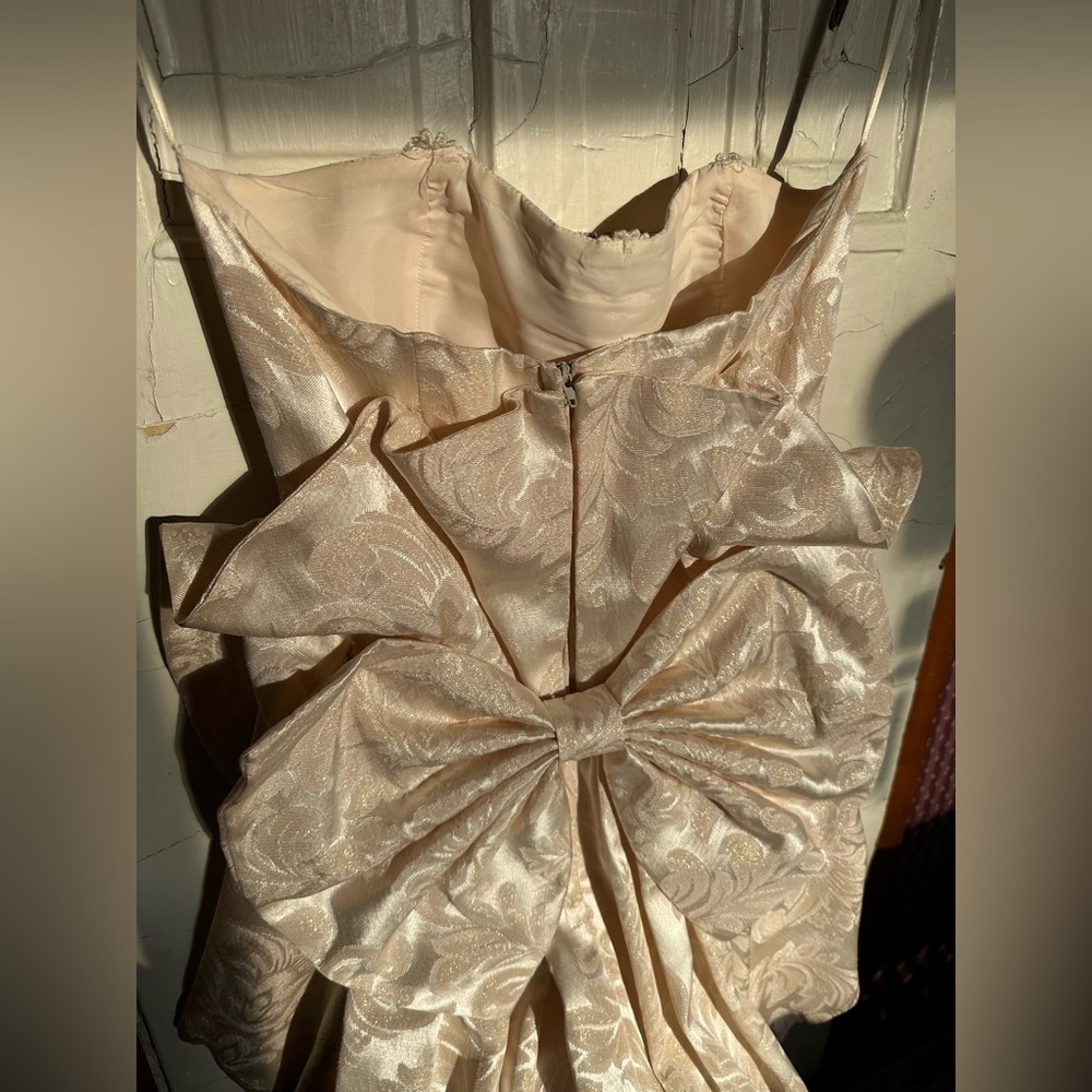 Vintage wedding dress with gold accents and bow